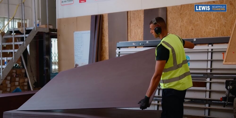 cutting the wood scaffold toe-boards